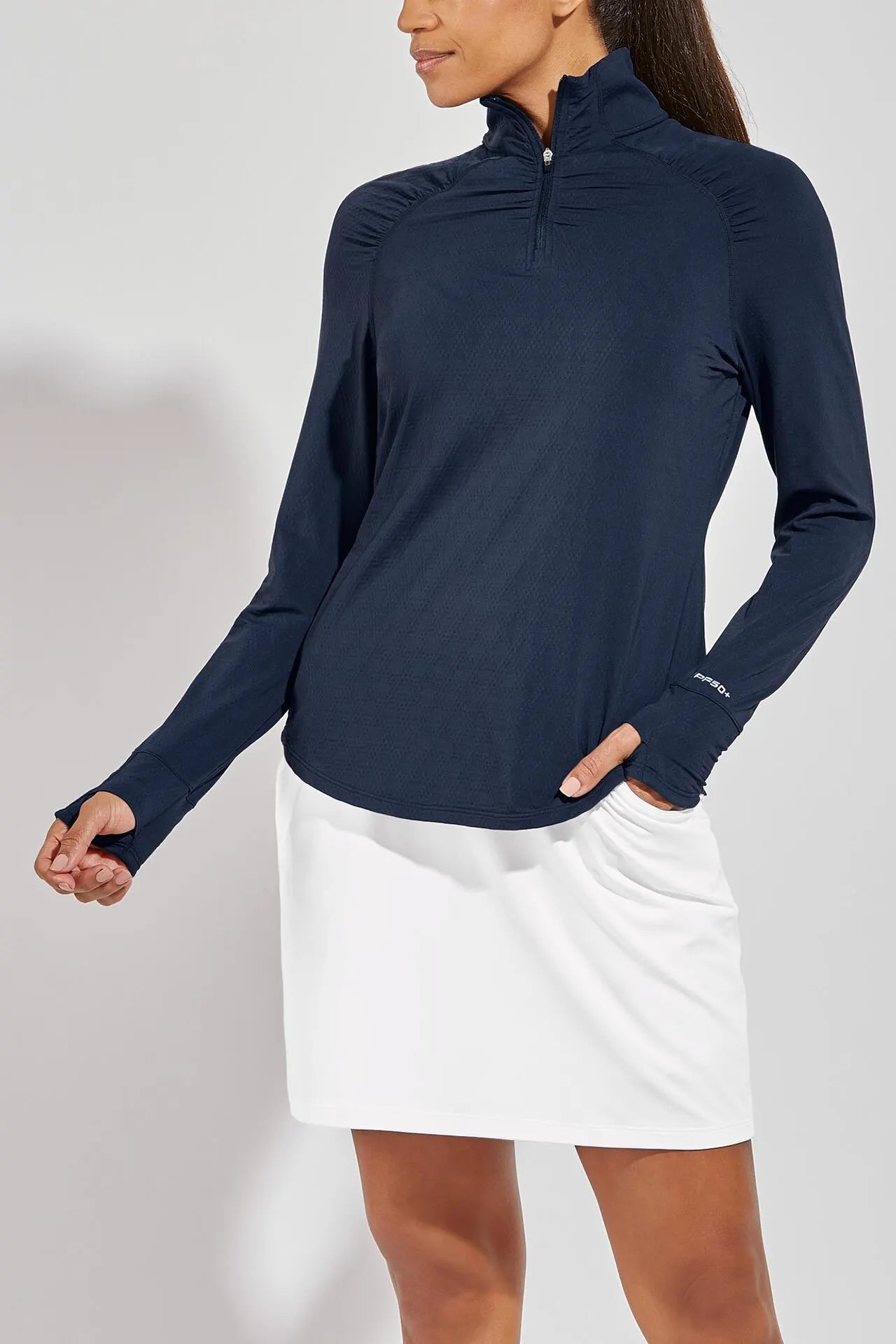 Front image of Coolibar arabella quarter zip pullover top. Navy long sleeve top.