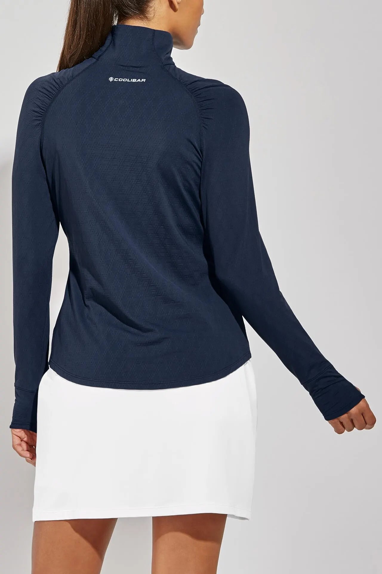 Back image of Coolibar arabella quarter zip pullover top. Navy long sleeve top.