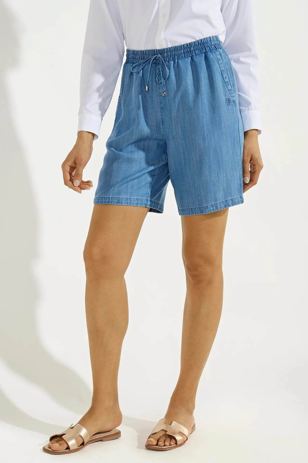 Front image of Coolibar enclave chambray shorts. Pull on light indigo shorts.
