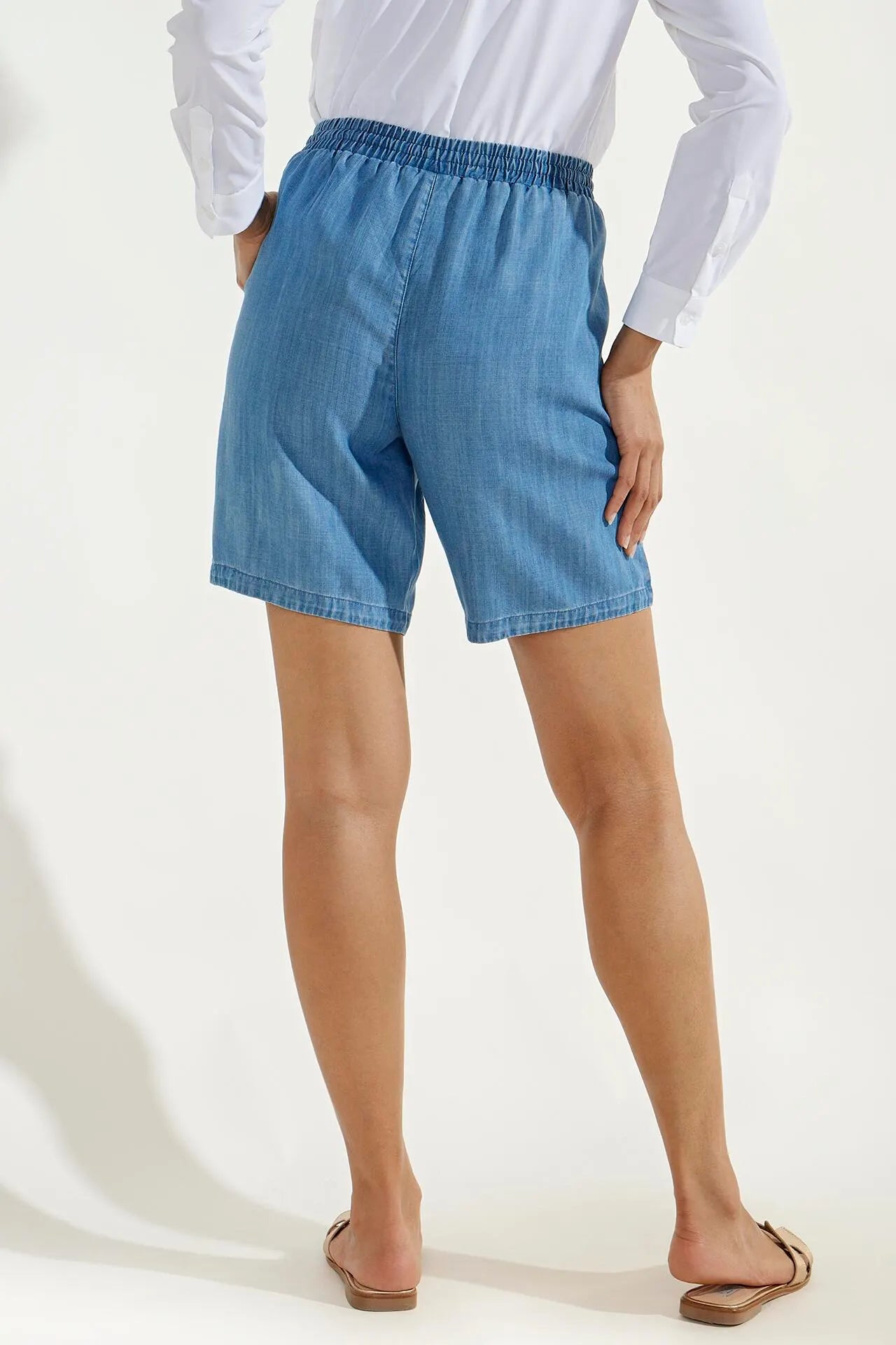 Back image of Coolibar enclave chambray shorts. Pull on light indigo shorts.