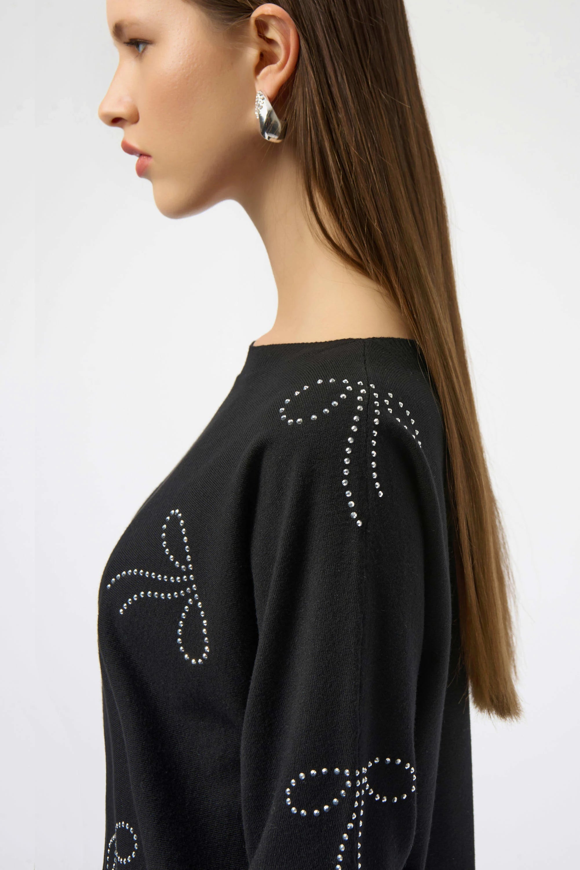 Close Up detail View Image of Joseph Ribkoff Sweater Knit Pullover with Iron-On Bow Detail in Black