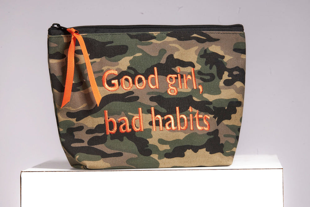 Front image of cosmetic bag. Good girl, bad habits. 