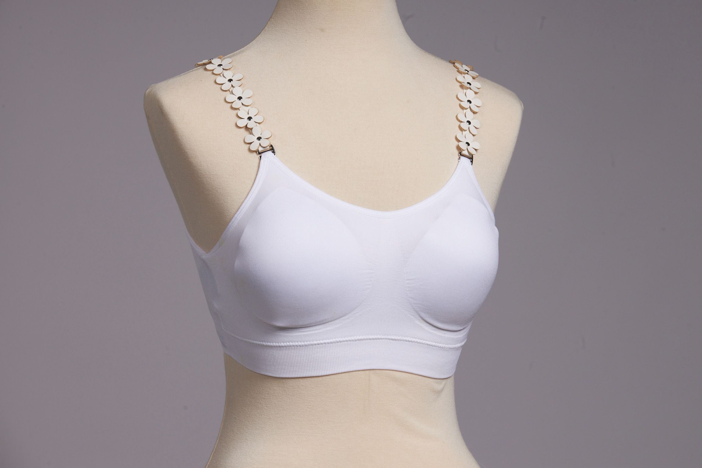 Front image of strap its white vegan flower bra.
