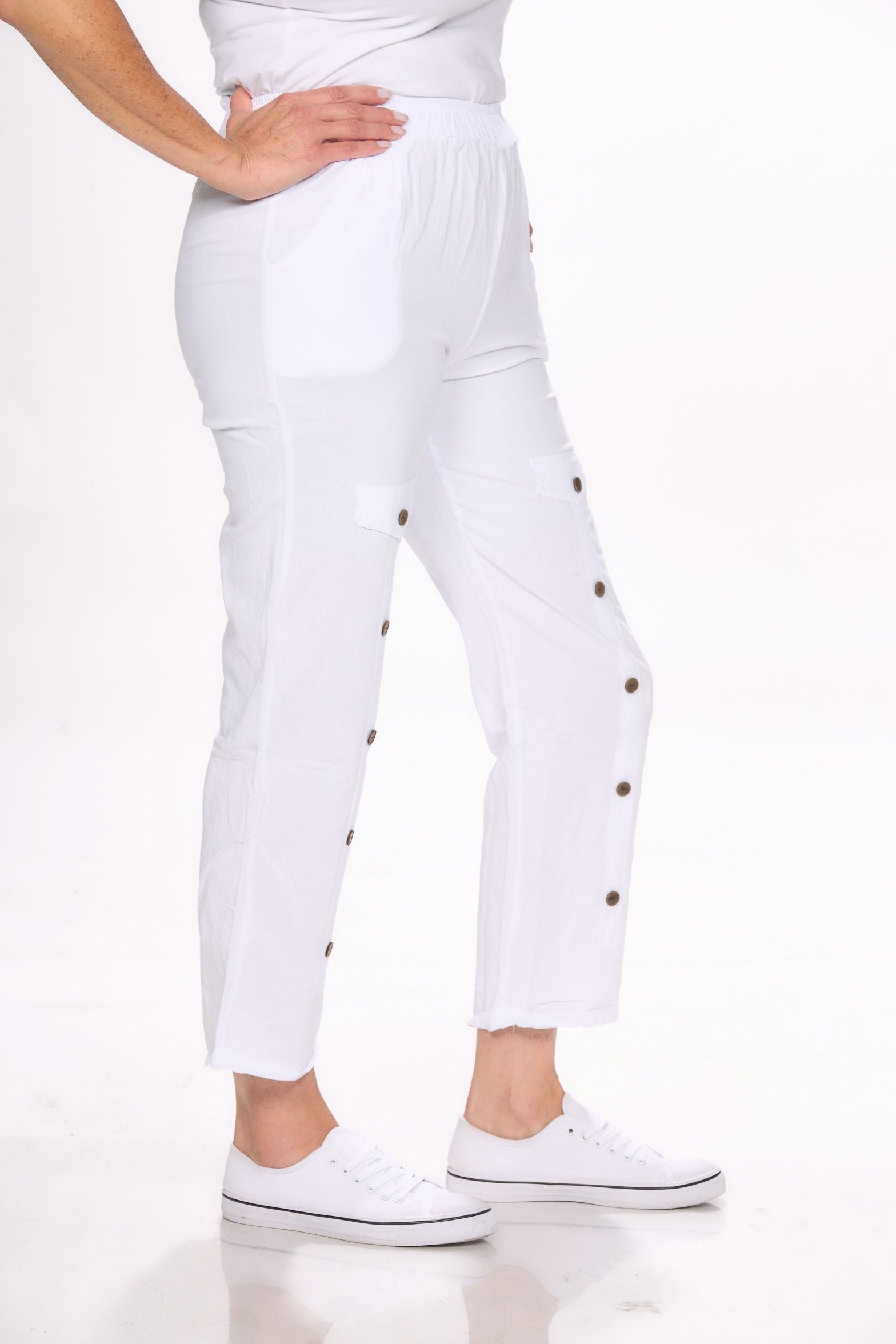 Side image of white pull on button detail pants by Giocam.