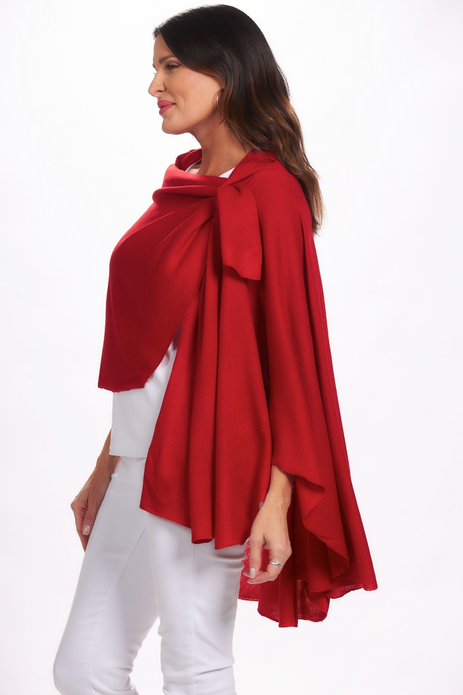 Side image of magic scarf loop and pull through wrap. Red drapey cardigan.