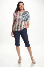 Front image of short sleeve tee with sequins in flag and rose print. 