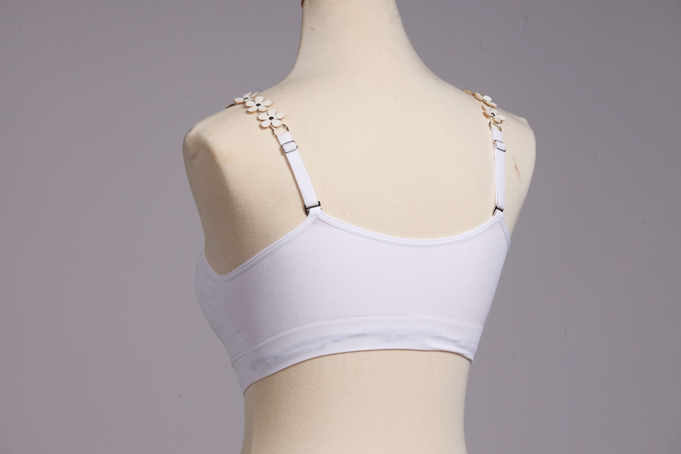 Back image of strap its white vegan flower bra.