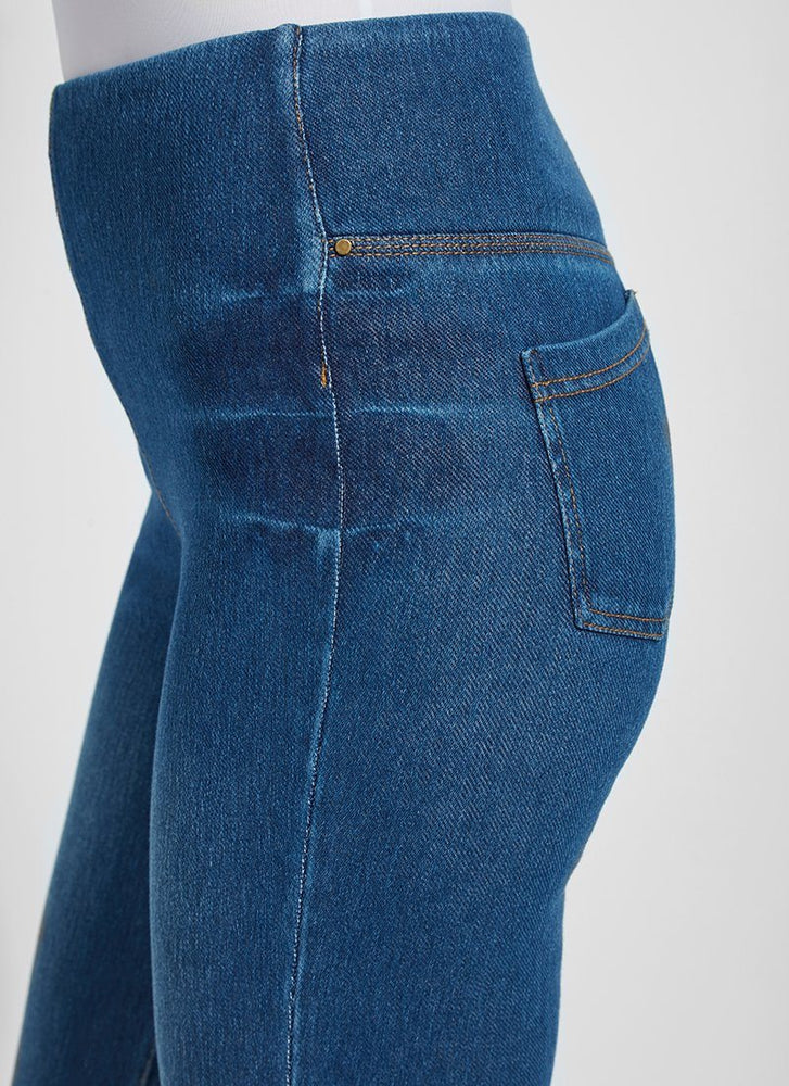 Side View Closeup Image of Mid Wash jeans with back pockets and cuffed leg, Boyfriend Denim