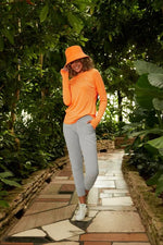 Front image of Coolibar Devi long sleeve fitness t-shirt. Apricot crush long sleeve top. 