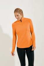 Front image of Coolibar arabella quarter zip pullover. Apricot orange top. 