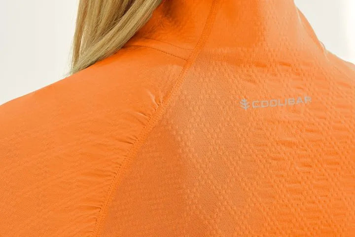 Detail image of Coolibar arabella quarter zip pullover. Apricot orange top. 