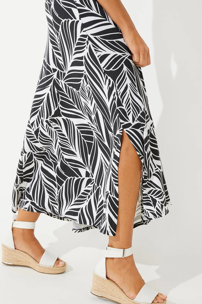 Detail side image of Coolibar Fabyan Maxi Skirt. Black and white coconut palm printed skirt. 