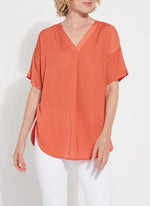 Front image of Lysse Stevie Top in vibrant apricot. Short sleeve fashion top. 