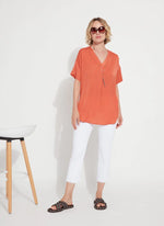 Front image of Lysse Stevie Top in vibrant apricot. Short sleeve fashion top. 