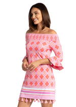 Front image of off the shoulder dress. Coral geo printed dress with tassels. 