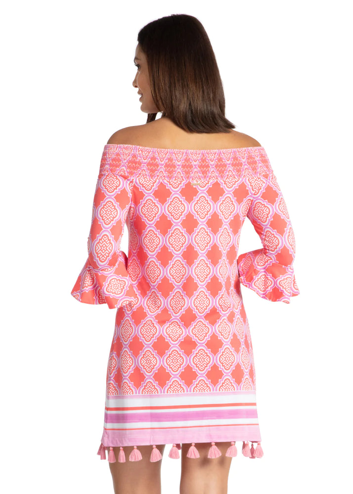 Back image of off the shoulder dress. Coral geo printed dress with tassels. 