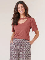 Front image of Democracy puff sleeve crochet cutout top. Henna copper orange color. 