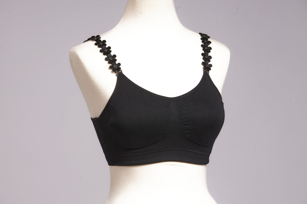 Front image of black strap its bra. Black vegan leather flower strap. 