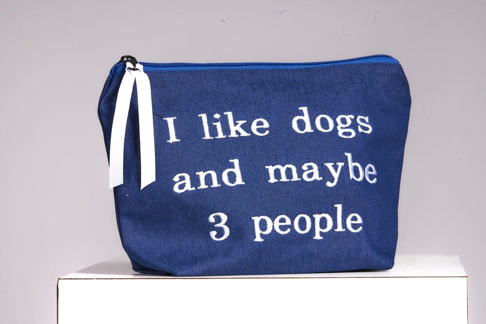 Front image of cosmetic bag. I like dogs and maybe 3 people. 