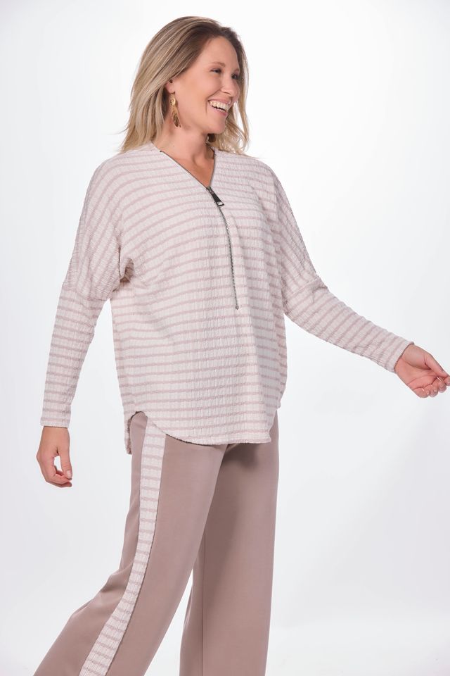 Side image of long sleeve zip front striped sweater.