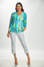 Full front view 3/4 sleeve v-neck top in blue/green circle print