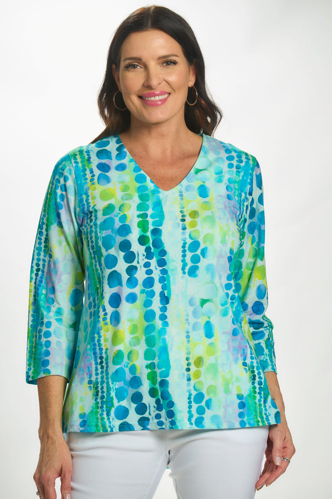 Front view 3/4 sleeve v-neck top in blue/green circle print
