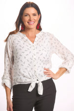 Front image of white button front blouse with the word "love" print