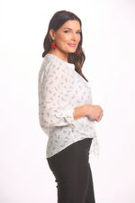 Side image of button up white blouse with red heart print