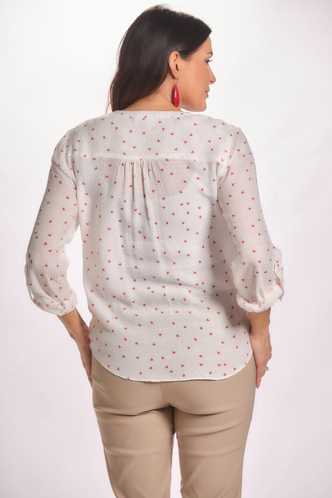 Back image of button up white blouse with red heart print