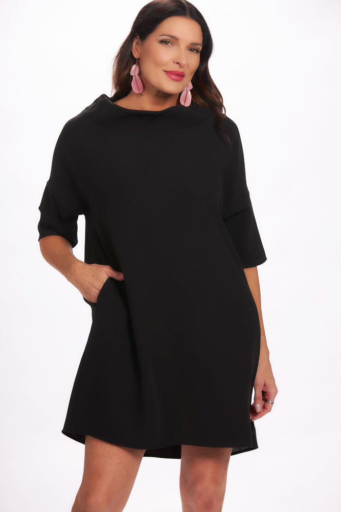 Front view black shift dress with cowl neck and hidden pockets