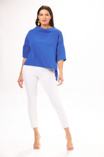 Full Body View Image of Suzy D London Electric Blue high Low Cowl Neck Top , paired  with Tribal White jean. Cowl Neck Top