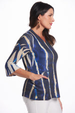 Side image of impluse bell sleeve top with pockets. Blue slanted lines print. Top with pockets. 