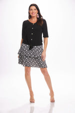 Front image of Mimozza black and white feather printed ruffle skort. 
