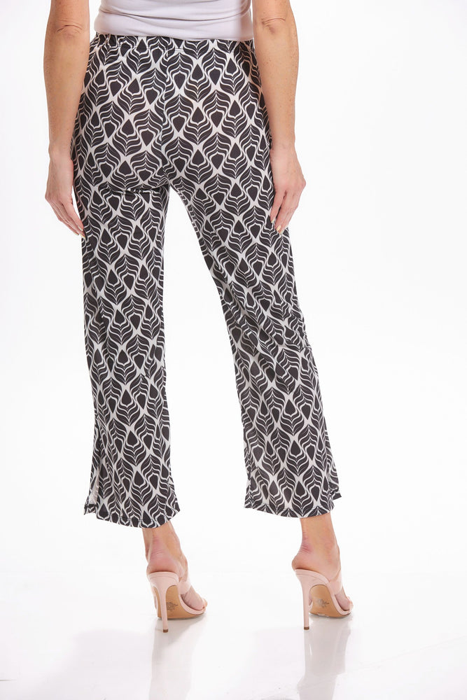 Back image of Mimozza pull on side slit ankle pants. Black and white feather printed pants. 