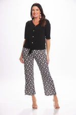 Front image of Mimozza pull on side slit ankle pants. Black and white feather printed pants. 