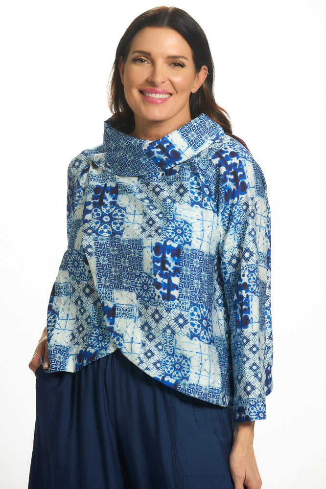 Front image of Shana short printed crushed jacket. Blue cowl neck top. 
