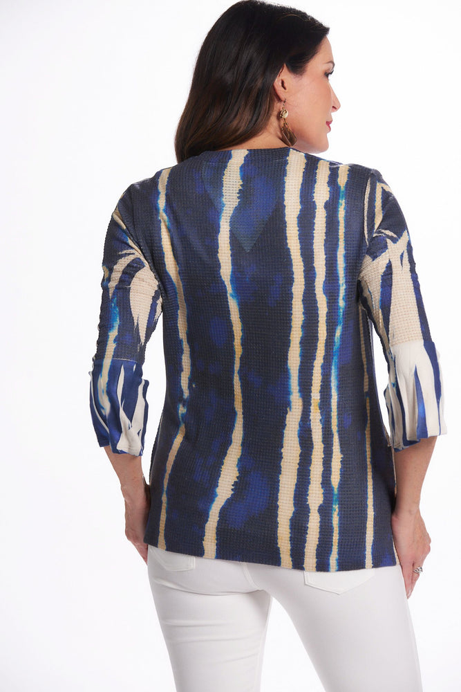 Back image of impluse bell sleeve top with pockets. Blue slanted lines print. Top with pockets. 