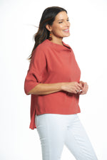 Side image of Suzy D London cowl neck top in brick.