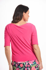 Back image of Mimozza short sleeve v-neck button front tie top. Bright pink destination collection top. 