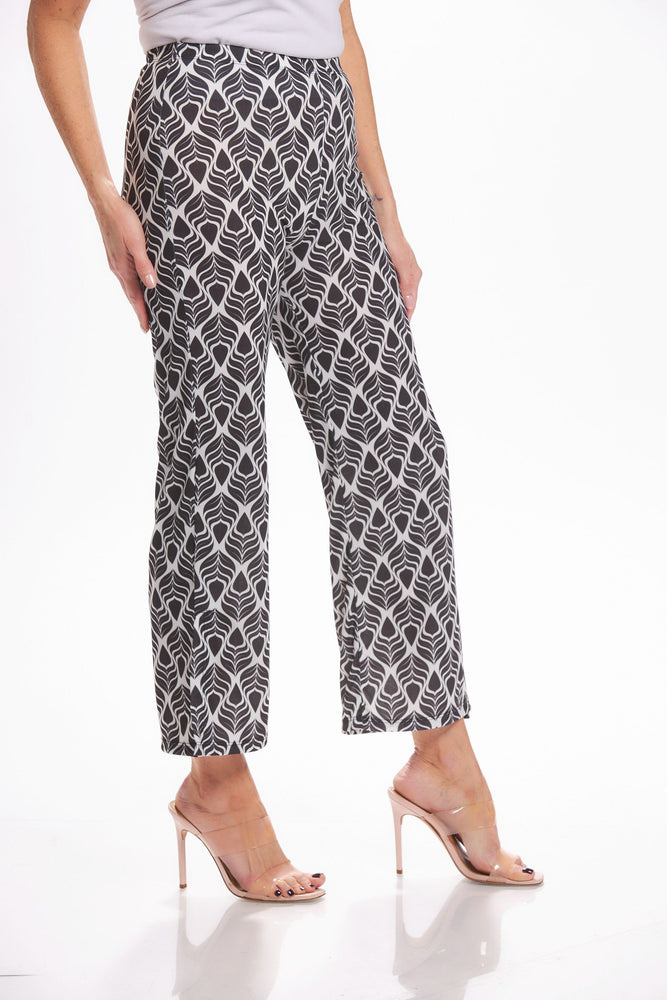 Side image of Mimozza pull on side slit ankle pants. Black and white feather printed pants. 
