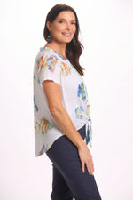 Side image of short sleeve impluse blue fish top. Tie front button front top. 