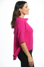 Side image of suzy d london cowl neck top. Hot pink sweater top. 