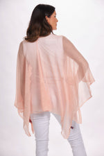 Back image of the magic scarf company lightweight ruana. Light pink shawl. 