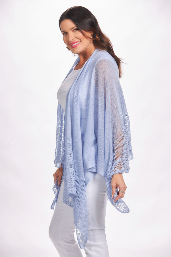 Side image of the magic scarf top. Lightweight knit ruana in light blue. 