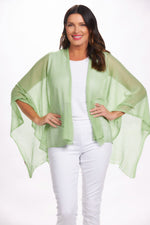 Front image of the magic scarf lightweight knit ruana. Mint green shawl. 
