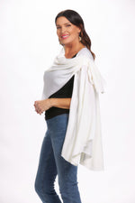 Side image of off white loop pull through wrap. White open front cardigan. 