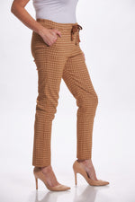 Side image of camel houndstooth printed pants. Made in italy pull on pants. 
