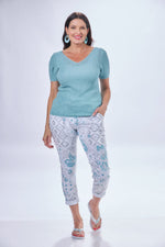Front image of heart print pants. Pull on printed jeggings. White and blue printed pants. 