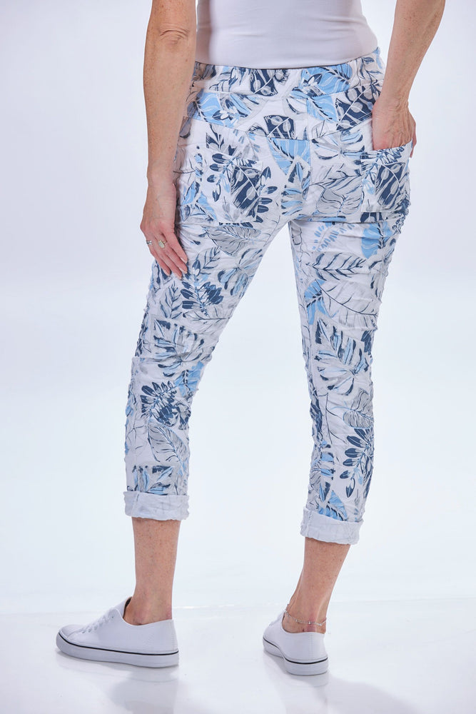 Back image of look mode tropical leaf jeggings. White floral printed pull on jeggings. 