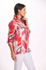 Side image of Fashion Cage cinched henley wire collar top. Red printed top. 